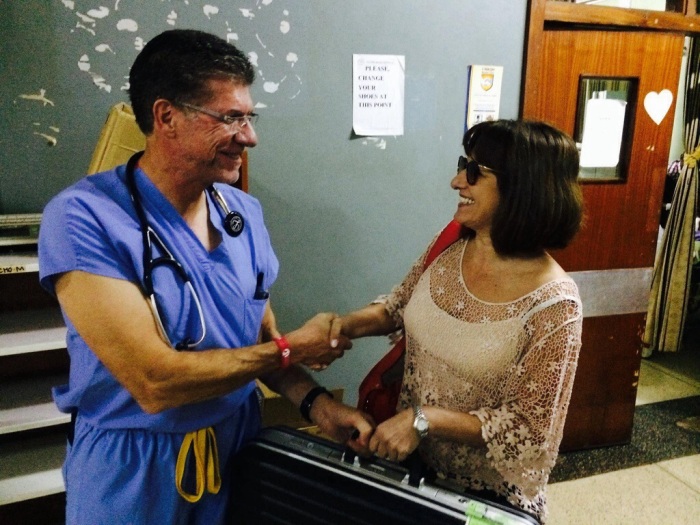 Lucy, Nurse who travels with Chain of Hope Missions handing off the TEE probe to Dr. Cordes